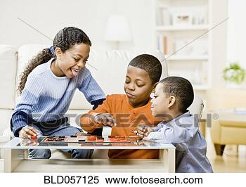 Stock Image - mixed race siblings 
playing checkers. 
fotosearch - search 
stock photos, 
pictures, images, 
and photo clipart