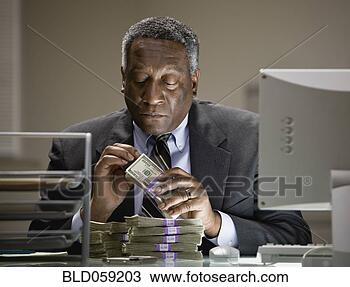 Stock Photo - african businessman 
counting money. 
fotosearch - search 
stock photos, 
pictures, images, 
and photo clipart
