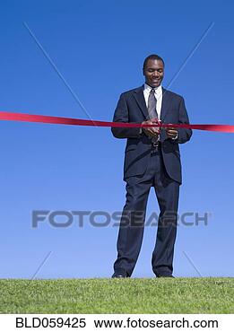 Stock Image - african businessman 
cutting ribbon. 
fotosearch - search 
stock photos, 
pictures, images, 
and photo clipart