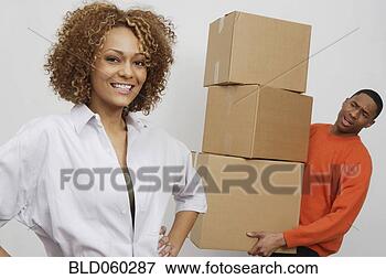 Picture - african man carrying moving boxes. fotosearch - search stock photos, pictures, wall murals, images, and photo clipart