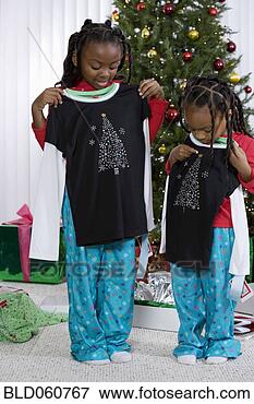 Picture - african sisters 
holding matching 
christmas gifts. 
fotosearch - search 
stock photos, 
pictures, images, 
and photo clipart