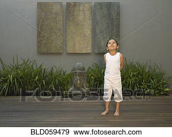 Stock Photograph - eurasian girl 
next to buddha 
statue. fotosearch 
- search stock 
photos, pictures, 
images, and photo 
clipart