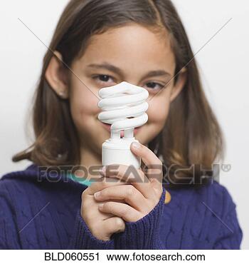 Stock Photography - hispanic girl 
holding energy 
efficient light 
bulb. fotosearch 
- search stock 
photos, pictures, 
images, and photo 
clipart