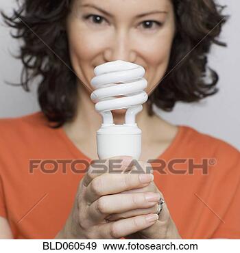 Stock Photograph - hispanic woman 
holding energy 
efficient light 
bulb. fotosearch 
- search stock 
photos, pictures, 
images, and photo 
clipart