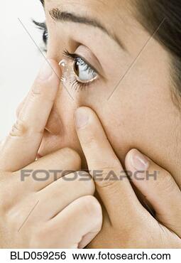 Stock Photo - hispanic woman 
putting in contact 
lens. fotosearch 
- search stock 
photos, pictures, 
images, and photo 
clipart