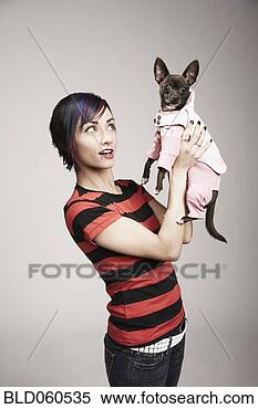 Stock Image - mixed race woman 
holding dog. fotosearch 
- search stock 
photos, pictures, 
images, and photo 
clipart