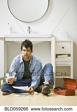 Stock Photo - native american 
man assembling 
bathroom plumbing. 
fotosearch - search 
stock photos, 
pictures, images, 
and photo clipart