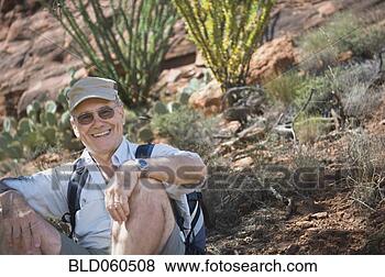 Stock Photo - senior man sitting 
on ground. fotosearch 
- search stock 
photos, pictures, 
images, and photo 
clipart
