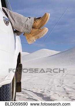 Stock Photography - woman’s feet in 
work boots hanging 
out of truck window. 
fotosearch - search 
stock photos, 
pictures, images, 
and photo clipart