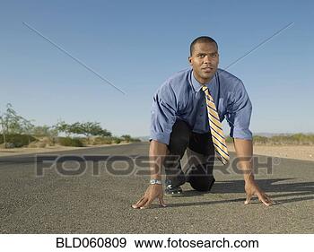 Stock Photograph - african businessman 
in racing starting 
position. fotosearch 
- search stock 
photos, pictures, 
images, and photo 
clipart