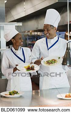Stock Photograph - african chefs 
holding plates 
of food. fotosearch 
- search stock 
photos, pictures, 
images, and photo 
clipart