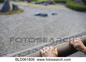 Stock Photo - hands on railing 
next to zen rock 
garden. fotosearch 
- search stock 
photos, pictures, 
images, and photo 
clipart