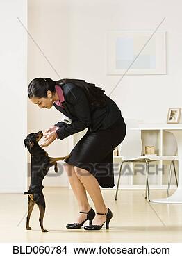 Stock Photo - hispanic businesswoman 
petting dog. fotosearch 
- search stock 
photos, pictures, 
images, and photo 
clipart
