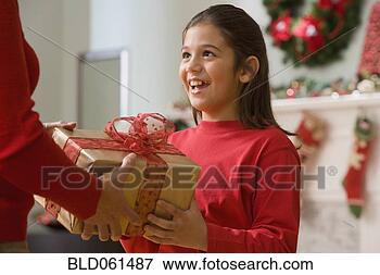 Picture - hispanic girl 
receiving christmas 
gift. fotosearch 
- search stock 
photos, pictures, 
images, and photo 
clipart