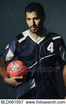 Picture - hispanic male 
soccer player 
holding ball. 
fotosearch - search 
stock photos, 
pictures, images, 
and photo clipart