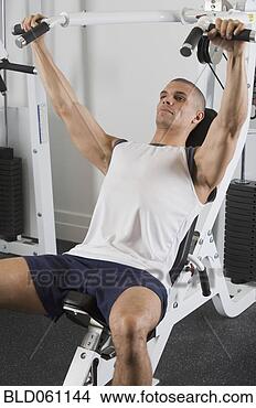 Stock Photo - hispanic man exercising 
in gym. fotosearch 
- search stock 
photos, pictures, 
images, and photo 
clipart