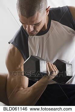 Stock Photo - hispanic man lifting 
free weights. 
fotosearch - search 
stock photos, 
pictures, images, 
and photo clipart