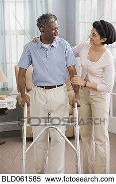 Stock Image - middle eastern 
woman helping 
man use walker. 
fotosearch - search 
stock photos, 
pictures, images, 
and photo clipart