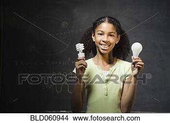Stock Photo - mixed race girl 
holding light 
bulbs. fotosearch 
- search stock 
photos, pictures, 
images, and photo 
clipart