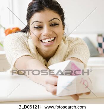 Stock Photography - mixed race woman 
holding origami 
fortune teller. 
fotosearch - search 
stock photos, 
pictures, images, 
and photo clipart
