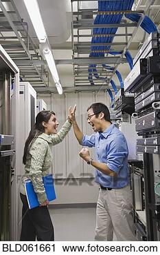 Stock Photography - multi-ethnic coworkers 
high-fiving in 
computer server 
room. fotosearch 
- search stock 
photos, pictures, 
images, and photo 
clipart