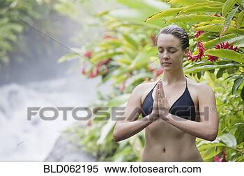 Stock Image - woman praying 
in tropical location. 
fotosearch - search 
stock photos, 
pictures, images, 
and photo clipart