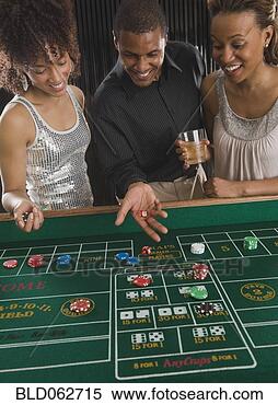 Stock Image - african man and 
women playing 
craps at casino. 
fotosearch - search 
stock photos, 
pictures, images, 
and photo clipart