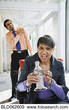 Stock Photograph - angry african 
businesswoman 
holding voodoo 
doll of co-worker. 
fotosearch - search 
stock photos, 
pictures, images, 
and photo clipart