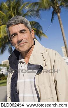 Stock Photo - cuban man standing 
in front of palm 
trees. fotosearch 
- search stock 
photos, pictures, 
images, and photo 
clipart