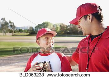 Stock Photo - hispanic baseball 
player and coach 
talking. fotosearch 
- search stock 
photos, pictures, 
images, and photo 
clipart