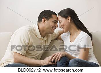 Stock Photo - hispanic couple 
face to face on 
sofa. fotosearch 
- search stock 
photos, pictures, 
images, and photo 
clipart