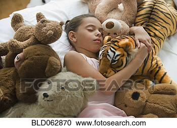 Stock Photography - hispanic girl 
sleeping in bed 
surrounded by 
stuffed animals. 
fotosearch - search 
stock photos, 
pictures, images, 
and photo clipart