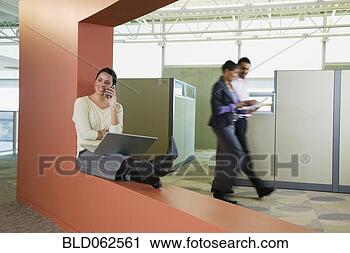 Stock Photography - latin american 
businesswoman 
with laptop talking 
on cell phone 
in. fotosearch 
- search stock 
photos, pictures, 
images, and photo 
clipart