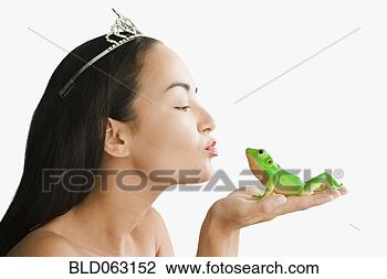 Stock Photo - mixed race woman 
with tiara kissing 
toy frog. fotosearch 
- search stock 
photos, pictures, 
images, and photo 
clipart