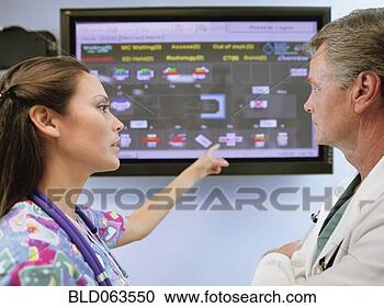 Stock Photography - multi-ethnic doctors 
looking at diagram. 
fotosearch - search 
stock photos, 
pictures, images, 
and photo clipart