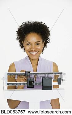 Picture - african woman 
weighing herself 
on scale. fotosearch 
- search stock 
photos, pictures, 
images, and photo 
clipart