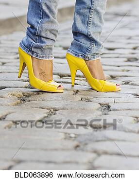 Stock Photo - close up of african 
woman wearing 
yellow high heels. 
fotosearch - search 
stock photos, 
pictures, images, 
and photo clipart