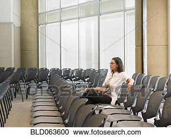 Stock Photography - hispanic businesswoman 
waiting in empty 
conference room. 
fotosearch - search 
stock photos, 
pictures, images, 
and photo clipart