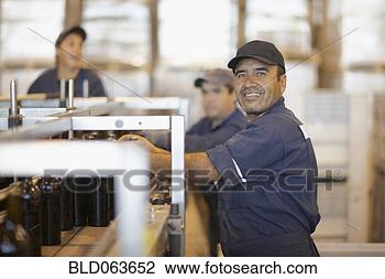 Stock Photo - hispanic man working 
in bottling factory. 
fotosearch - search 
stock photos, 
pictures, images, 
and photo clipart