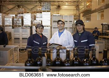Stock Photography - hispanic men working 
in bottling factory. 
fotosearch - search 
stock photos, 
pictures, images, 
and photo clipart