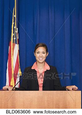 Stock Photo - mixed race businesswoman 
standing at podium. 
fotosearch - search 
stock photos, 
pictures, images, 
and photo clipart
