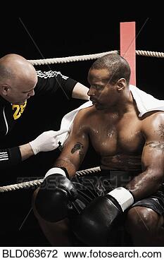 Stock Photo - trainer talking 
to african boxer 
in ring. fotosearch 
- search stock 
photos, pictures, 
images, and photo 
clipart