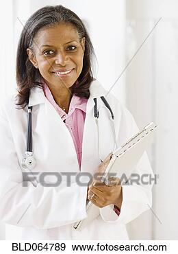 Stock Photograph - african doctor 
standing with 
medical chart. 
fotosearch - search 
stock photos, 
pictures, images, 
and photo clipart