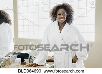 Stock Photography - african woman 
wearing bathrobe 
in bathroom. fotosearch 
- search stock 
photos, pictures, 
images, and photo 
clipart