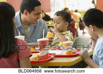 Stock Photo - hispanic family 
eating in fast 
food restaurant. 
fotosearch - search 
stock photos, 
pictures, images, 
and photo clipart