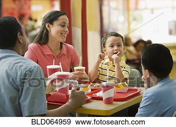 Stock Photograph - hispanic family 
eating in fast 
food restaurant. 
fotosearch - search 
stock photos, 
pictures, images, 
and photo clipart