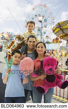 Stock Photo - hispanic family 
having fun at 
amusement park. 
fotosearch - search 
stock photos, 
pictures, images, 
and photo clipart