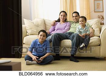 Stock Photo - hispanic family 
watching television 
in living room. 
fotosearch - search 
stock photos, 
pictures, images, 
and photo clipart