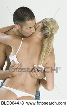Stock Photo - hispanic man unfastening 
girlfriends bra. 
fotosearch - search 
stock photos, 
pictures, images, 
and photo clipart