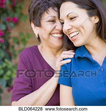 Stock Photo - hispanic mother 
and adult daughter 
hugging. fotosearch 
- search stock 
photos, pictures, 
images, and photo 
clipart